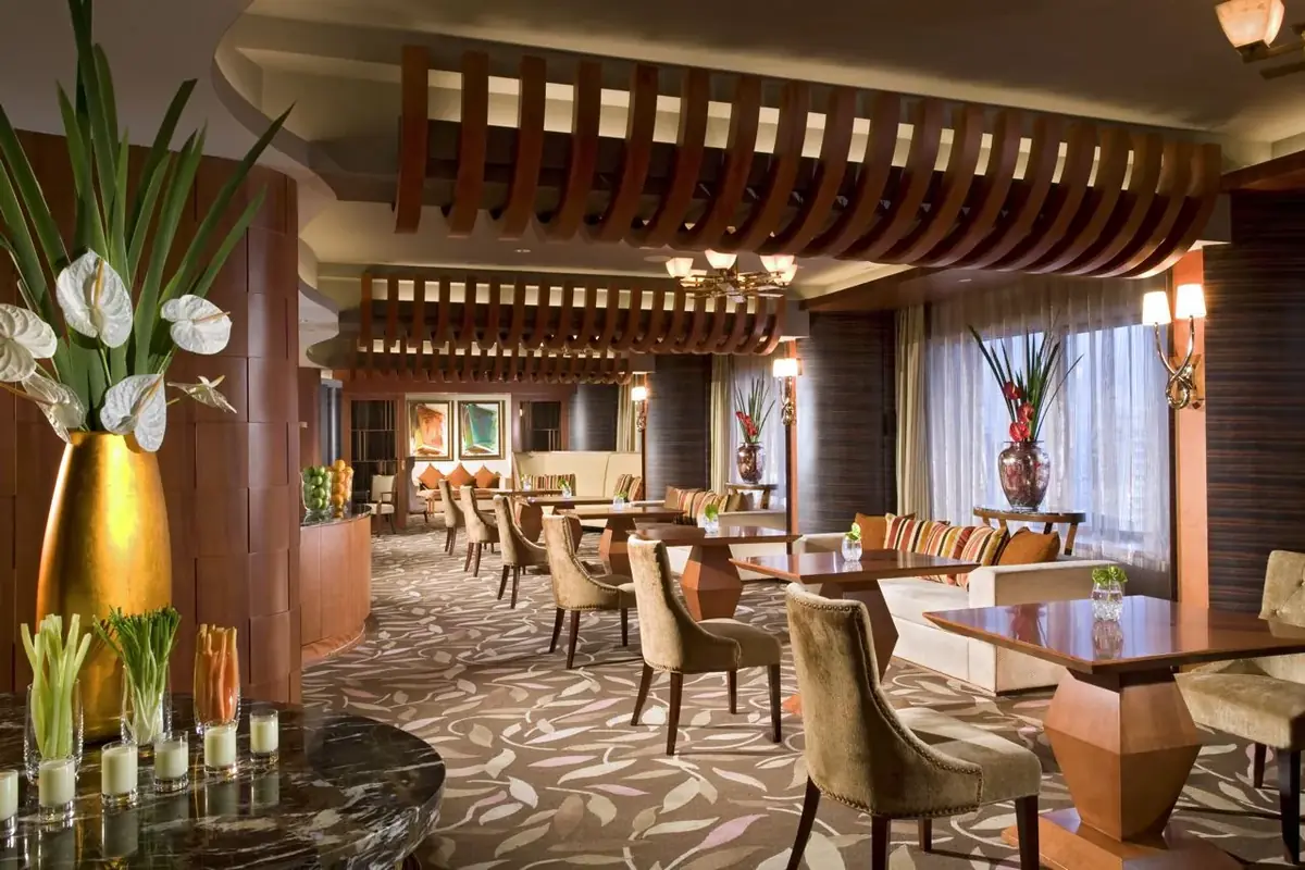 Executive lounge with upholstered seating and window treatments
