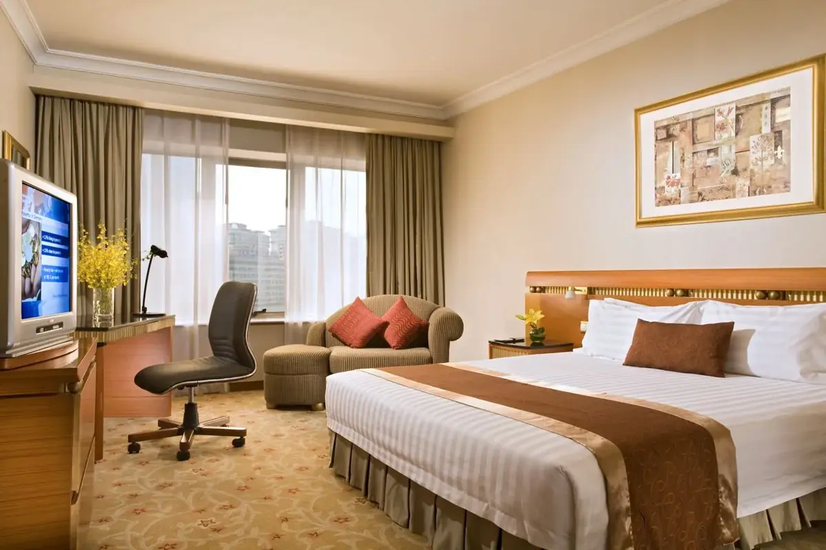 Hotel guest room with drapery and bedding