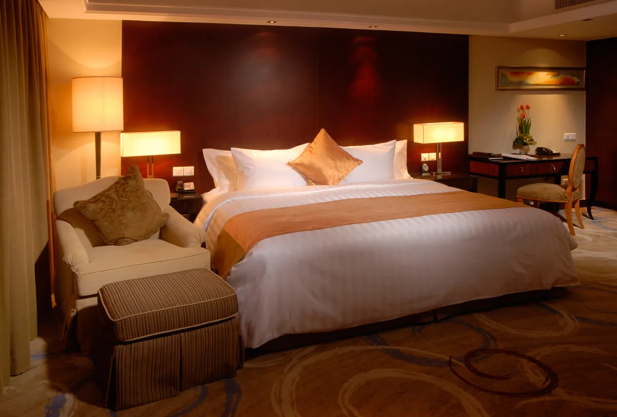 Suite bedroom with bed linen, cushions and curtains